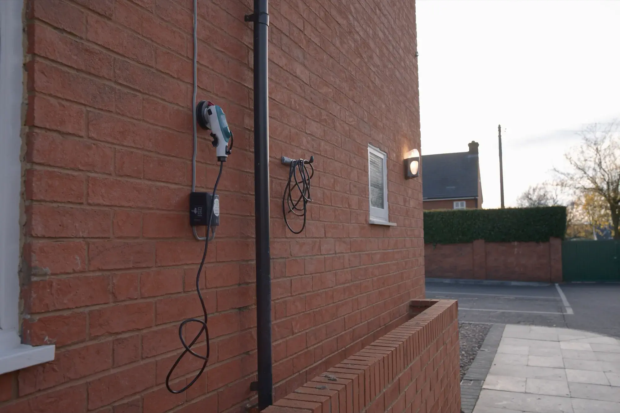 EV charge point on a brick house wall